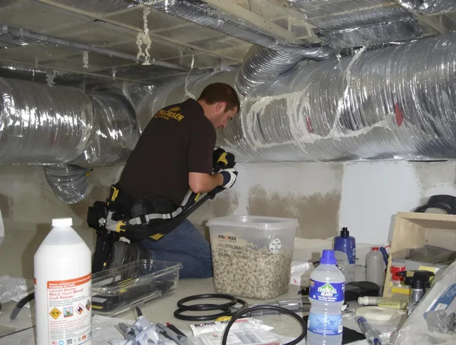Maynard Air Duct Cleaning specialist performing professional mold removal from air ducts in Maynard