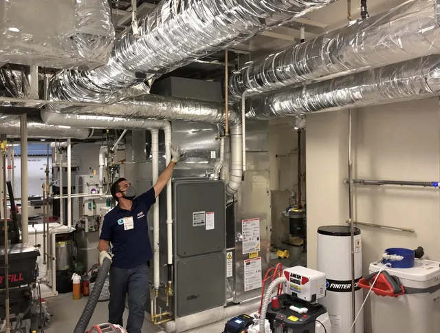 Maynard Air Duct Cleaning specialist performing thorough furnace duct cleaning in a Maynard residence