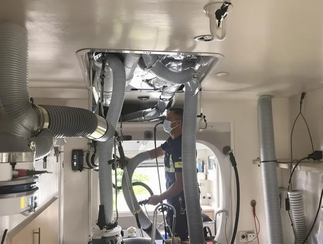 Maynard Air Duct Cleaning specialist performing precise mobile home duct cleaning in Maynard