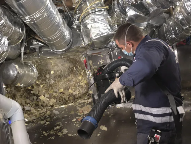 Maynard Air Duct Cleaning specialist operating negative pressure cleaning equipment for thorough duct maintenance in Maynard