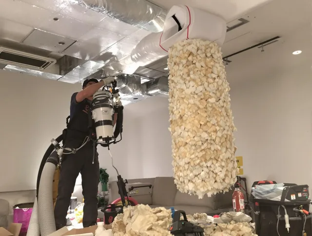 Maynard Air Duct Cleaning technician performing precision vacuum insulation removal in a residential property in Maynard