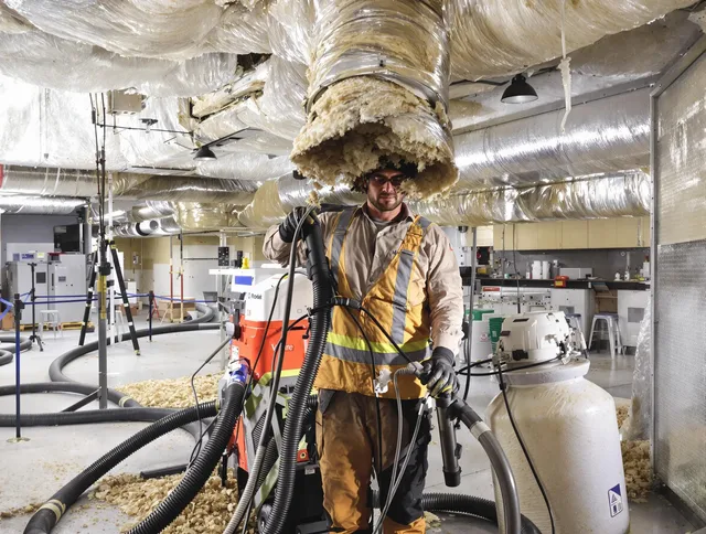 Professional vacuum insulation removal by Maynard Air Duct Cleaning expert in Maynard